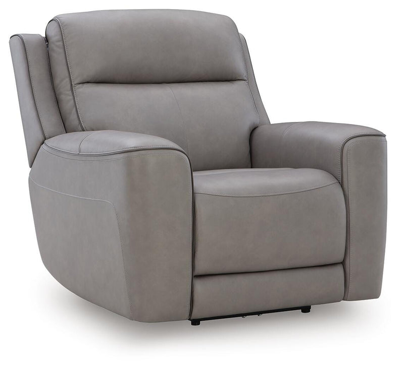 Ashley Furniture 5Z-Comfort Power Recliner with plush cushioning, side control panel, and dark brown upholstery, viewed from an angle.