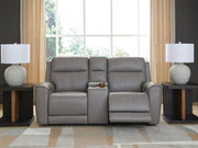 Ashley Furniture 5Z-Comfort Power Reclining Loveseat with Console, featuring plush fabric and built-in cup holders.