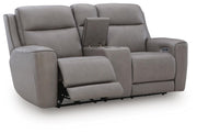 Ashley Furniture 5Z-Comfort Power Reclining Loveseat with Console, shown from an open angle highlighting plush upholstery and built-in cupholders.