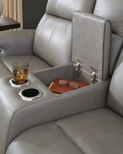 Ashley Furniture 5Z-Comfort Power Reclining Loveseat with Console, plush fabric, padded armrests, and built-in cup holders.