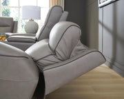 Ashley Furniture 5Z-Comfort power reclining loveseat with built-in console, featuring plush cushioning and dark upholstery.