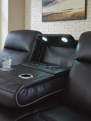 Ashley Furniture 5Z-Comfort Power Reclining Sofa with plush cushions and reclining features, shown in a detailed close-up image.