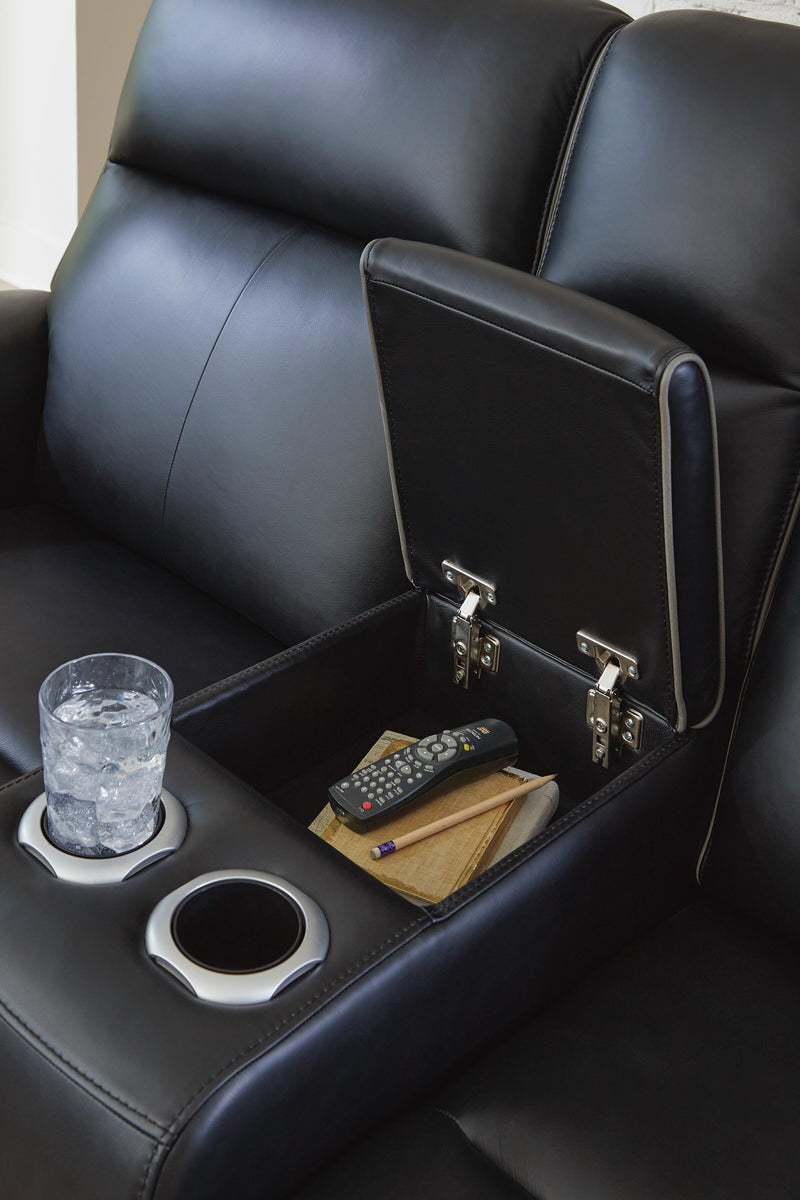 Close-up of Ashley Furniture 5Z-Comfort Power Reclining Living Room Set console with detailed stitching and rich upholstery.