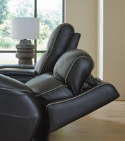 Ashley Furniture 5Z-Comfort Power Reclining Sofa shown with plush fabric, padded armrests, and built-in recline controls.