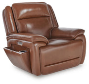 Ashley Furniture Healy Pier Power Recliner in dark brown leather, showing a closed reclined position from an angled view.