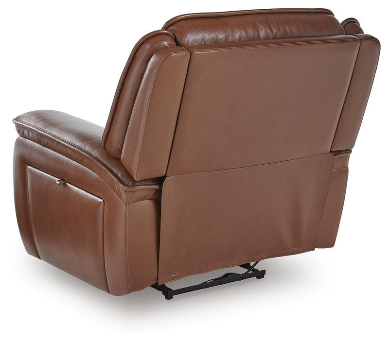 Ashley Furniture Healy Pier Power Recliner with plush fabric and padded armrests, shown from the back in a modern living room setting.