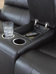 Close-up of Ashley Furniture Glossmore living room set reclining console with detailed stitching and dark upholstery.
