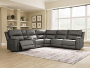 Ashley Furniture Bleckley power reclining sectional with plush cushions and dark upholstery, shown in a modern living room setting.