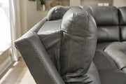 Ashley Furniture Bleckley power reclining sectional with plush cushions and reclining seats, shown in a modern living room setting.