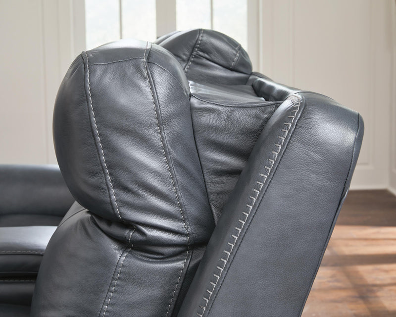 Ashley Furniture Next Move power reclining sofa with plush upholstery and built-in reclining features, shown in a modern living room setting.