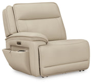Ashley Furniture Double Deal Reclining Sectional shown from an angle, with open chaise and storage compartments in a modern living room setting.