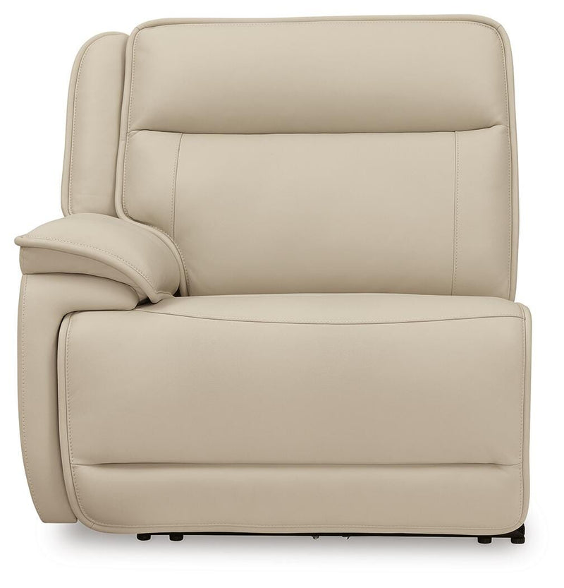 Ashley Furniture Double Deal reclining sectional with plush cushions and reclining seats, shown from a head-on view.