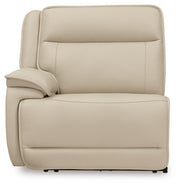 Ashley Furniture Double Deal Reclining Sectional with Console, showing plush fabric upholstery and reclining seats with built-in storage.