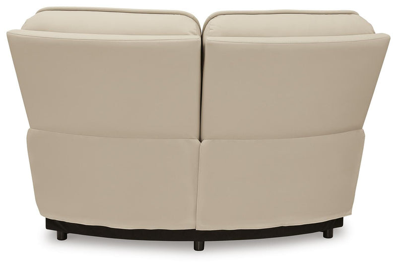 Ashley Furniture Double Deal reclining sectional with plush cushions and reclining seats, shown from the back in a modern living room setting.