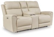Ashley Furniture Dahlmoore power reclining loveseat with built-in console, shown from an angled view in closed position.