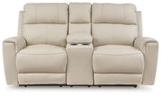 Ashley Furniture Dahlmoore power reclining loveseat with console, showing plush fabric, built-in cup holders, and reclined seating.