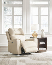 Open Dahlmoore Power Recliner by Ashley Furniture showing plush brown fabric, padded armrests, and reclining mechanism.