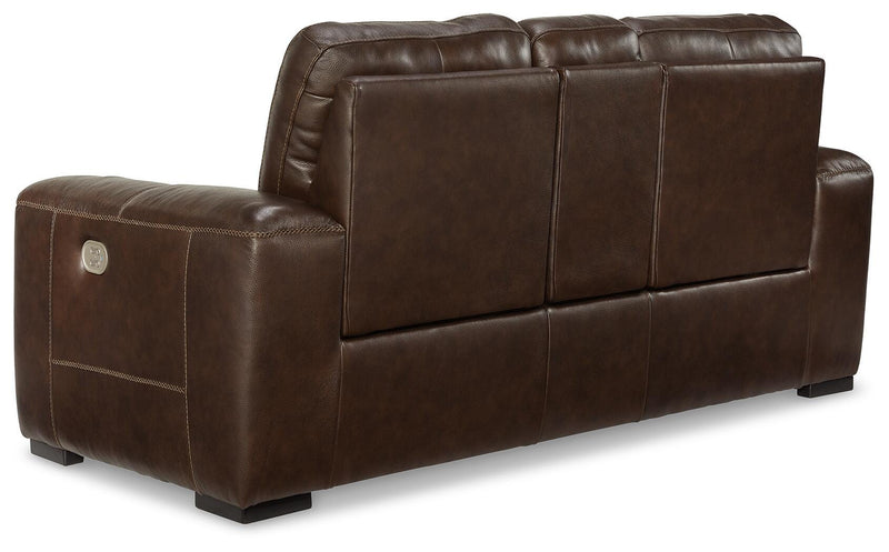 Ashley Furniture Alessandro power reclining loveseat with console, showing plush fabric and built-in cup holders in a cozy living room setting.