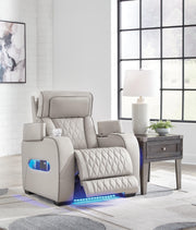 Boyington Power Recliner by Ashley Furniture showing plush upholstery, padded armrests, and reclining mechanism in a modern living room setting.