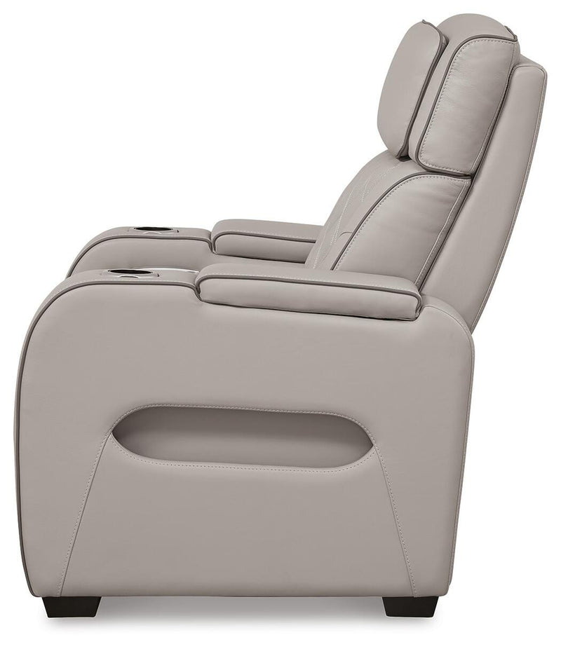 Ashley Furniture Boyington power recliner showing plush brown fabric, padded armrests, and reclining mechanism.