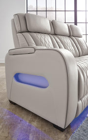 Side detail of Ashley Furniture Boyington Living Room Set showing fabric upholstery, armrest, and wooden legs.