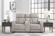 Boyington power reclining loveseat with console from Ashley Furniture, showing plush fabric, built-in cup holders, and reclining features.
