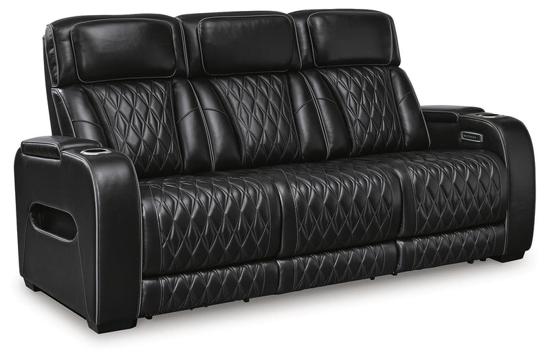 Ashley Furniture Boyington power reclining sofa shown from an angled view, featuring plush cushions and a dark leather finish.
