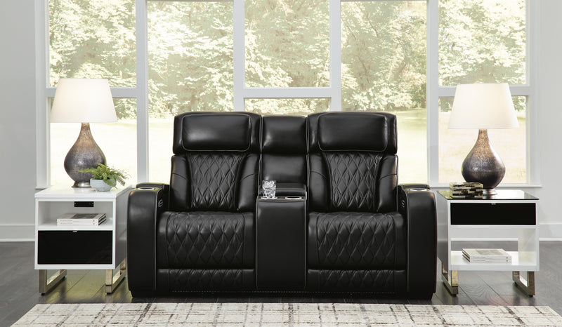Ashley Furniture Boyington power reclining loveseat with console, showing plush fabric, padded armrests, and built-in cup holders.
