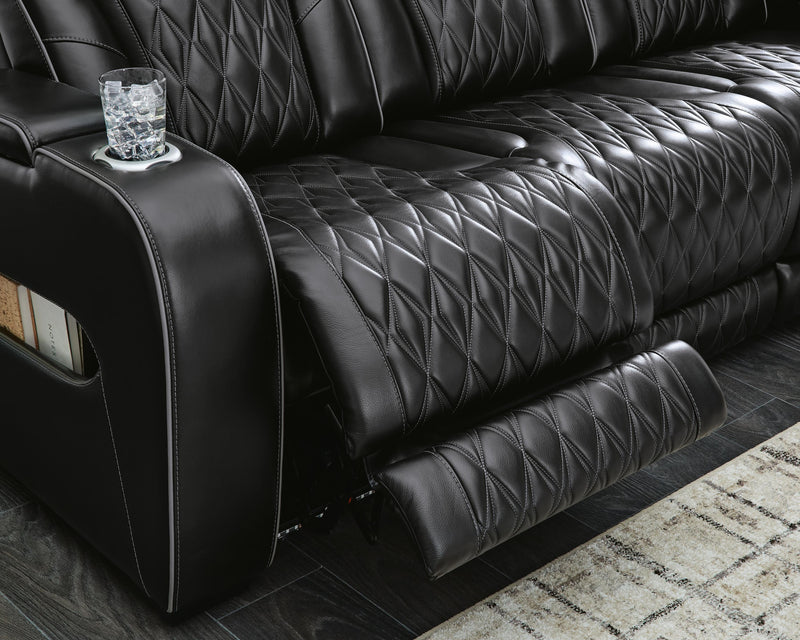 Ashley Furniture Boyington power reclining sofa with plush cushions and reclining features, shown in a modern living room setting.