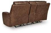 DeepWakes reclining living room set by Ashley Furniture, showing a plush sofa with reclining seats and overstuffed cushions.