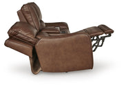 DeepWakes reclining living room set by Ashley Furniture, showing plush fabric cushions and reclining seats in a cozy living space