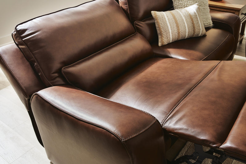 Ashley Furniture DeepWakes reclining living room set with plush cushions and wide armrests, shown in a modern living room setting.