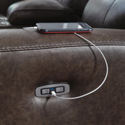 Ashley Furniture Crossplex power reclining loveseat with console featuring USB ports and stitched upholstery detail.