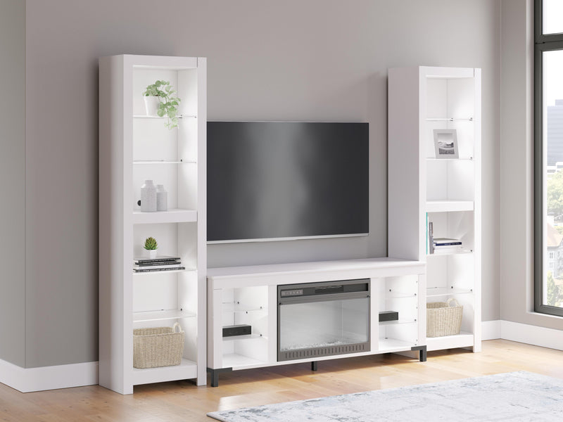 Ashley Furniture Brollevi entertainment center with white finish, featuring multiple shelves and compartments for media storage.