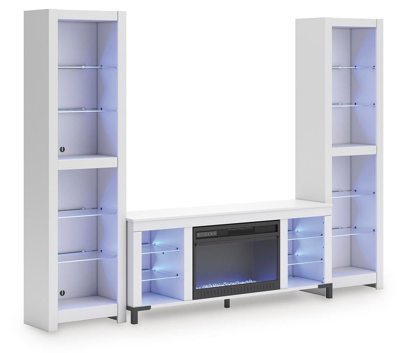 Ashley Furniture Brollevi entertainment center with blue finish, featuring shelves and storage compartments, angled view.