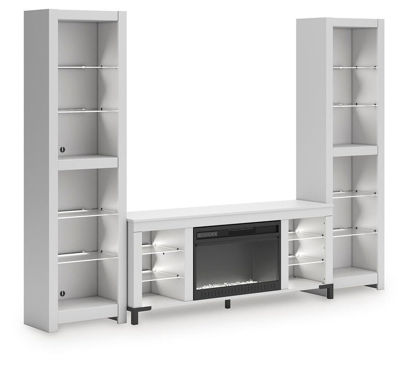 Ashley Furniture Brollevi entertainment center with white finish, featuring open shelving and storage cabinets, viewed from an angle.