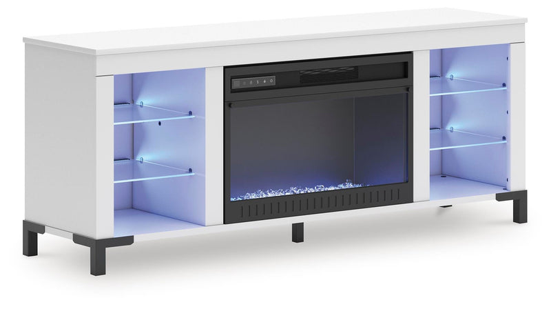 Ashley Furniture Brollevi 60-inch TV stand with electric fireplace, angled view showing wood finish and built-in fireplace feature.