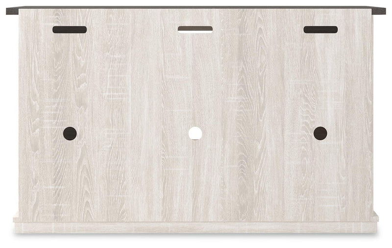 Ashley Furniture Dorrinson 54-inch TV stand with open shelving and dark wood finish, shown from the back with cable management holes.