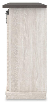 Ashley Furniture Dorrinson 54-inch TV stand with open shelves and side cabinets in a warm wood finish.