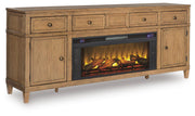 Ashley Furniture Sharlance 81-inch TV stand with electric fireplace, wood finish, and angled design.