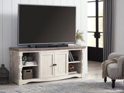Ashley Furniture Havalance 67-inch TV stand with open shelving and storage compartments in a modern wood finish.