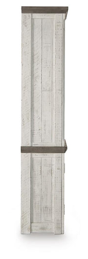 Ashley Furniture Havalance right pier cabinet with wood finish, featuring storage compartments and a decorative top surface.
