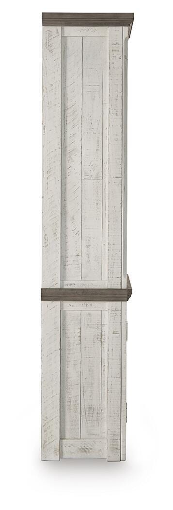 Ashley Furniture Havalance right pier cabinet with wood finish, featuring storage compartments and a decorative top surface.
