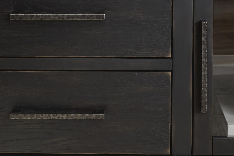 Detail view of the Ashley Furniture Galliden 80-inch TV stand showcasing its wood finish and spacious storage compartments.