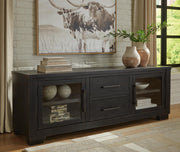 Ashley Furniture Galliden 80-inch TV stand with open shelving and storage drawers, crafted in a modern wood finish.