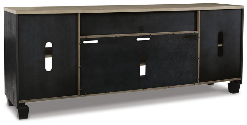 Ashley Furniture Foyland 83-inch TV stand with open shelves and storage cabinets, finished in a warm wood tone.