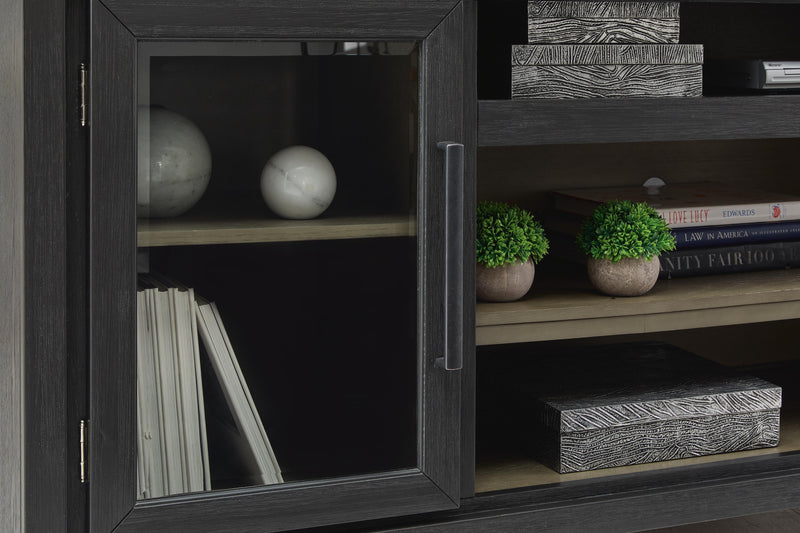 Ashley Furniture Foyland 83-inch TV stand with wood finish, featuring open shelves and storage cabinets.