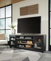 Ashley Furniture Foyland 83-inch TV Stand with open shelving and storage cabinets, made of wood in a dark finish.